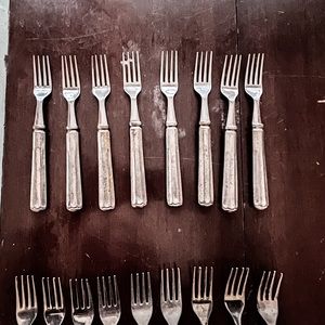 Pottery Barn Tivoli flatware. 9 knives. 9 dinner forks. 8 salad forks.